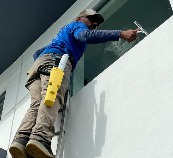 man cleaning the glass of office